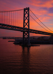 Fototapeta na wymiar SF Bay Bridge During Vibrant Red Sunset
