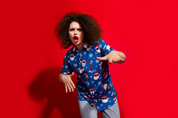 Photo portrait of lovely young lady dancing cheeky cool hip hop dressed stylish blue print x-mas garment isolated on red color background