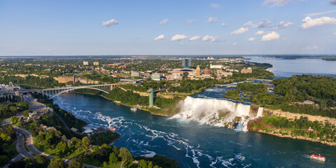 High angle, wide view of the American falls, Rainbow Bridge and Niagara river in Niagara Falls, Canada