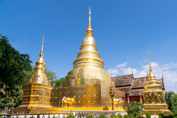 Fototapeta premium Chapel and golden pagoda at Wat Phra Singh Woramahawihan, famous travel destination in Chiang Mai, Thailand