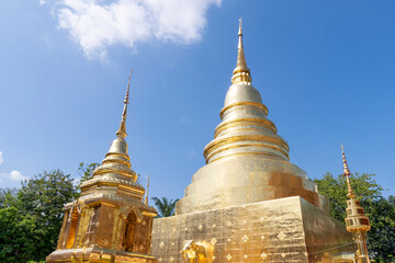 Naklejka premium Chapel and golden pagoda at Wat Phra Singh Woramahawihan, famous travel destination in Chiang Mai, Thailand