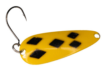 Macro image of a yellow and black fishing lure with a silver-colored hook. The pattern is commonly...