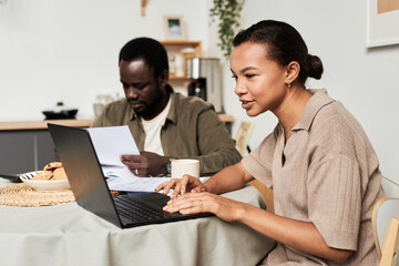 Side view portrait of Black young couple managing household together and doing taxes, copy space