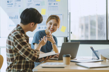 Young asian modern people in smart casual wear having meeting planning work together as a team and present ideas at work.