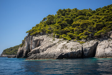 Rocky Cliff with Green Trees in Zakynthos. Greek Island Nature with Ionian Sea during Summer Day.