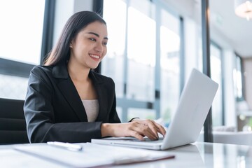 Beautiful&nbsp;confident asian business woman working with laptop Hands typing  keyboard. Professional investor working new start up project. business planning in office. Technology business