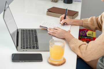 Happy young Asian Woman Successful working with laptop checking
