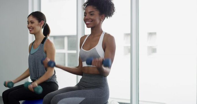 Smile, fitness and girl friends with weights for practice exercise, workout or training. Happy, energy and confident young women athletes with dumbbells for health, wellness and sport in a gym.