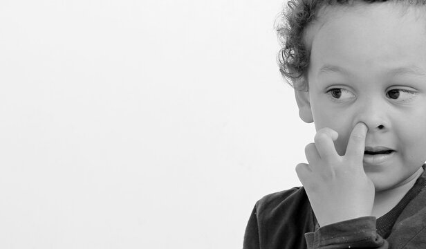 boy picking his nose with white background with people stock image stock photo