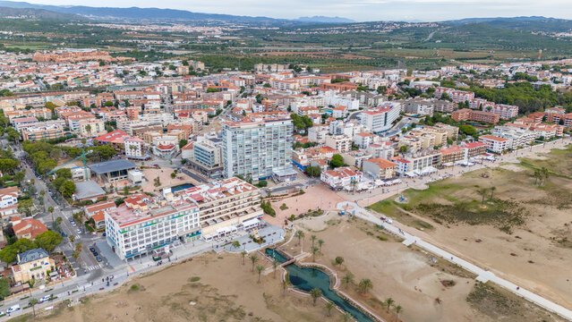 Aerial drone photo of the coastline and town centre of Comarruga in Spain