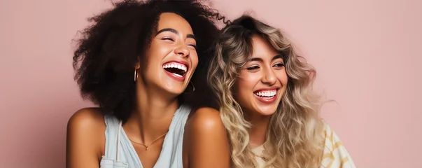 Fotobehang Scandinavian women smiles widely showing teeth alongside European girl friend. Cheerful best friends laugh together posing for photo. Young women of different races support each other © Stavros