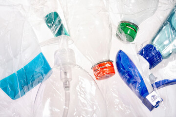 Plastic bottles in different colors with plastic foil
