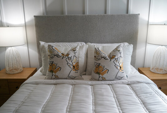 modern freshly made bed with pillows