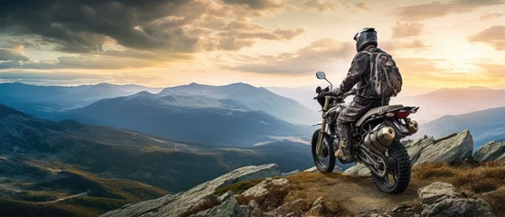 Fotobehang fearless biker perched at the edge of a rugged mountain cliff © Yash