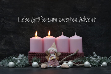 Adventsdekoration: Zwei rosa brennende Kerze mit Zweigen und Weihnachtskugeln vor einem dunklem Hintergrund mit dem Text Liebe Grüße zum zweiten Advent.