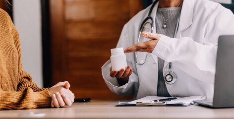 Doctor presenting with patient and checking results on report and prescription about the problem of illness and recommend using medicine, healthcare and medical concept.