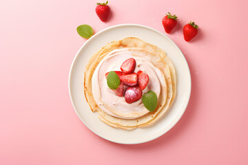 Top view of crepe with cream and strawberry fruits on pink background