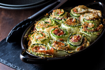 An appetizer of zucchini roll ups hot out of the oven, ready for serving.