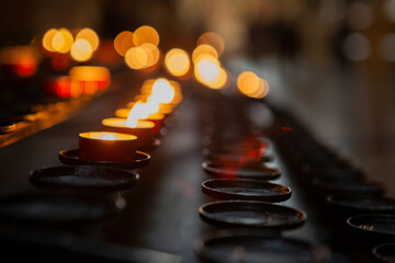 urning candles in a church . Selective focus. Beautiful background