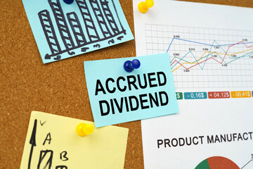 Business charts and stickers with the inscription hang on the board - ACCRUED DIVIDEND