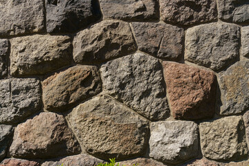 Texture of an old stone wall made of stone and cement.