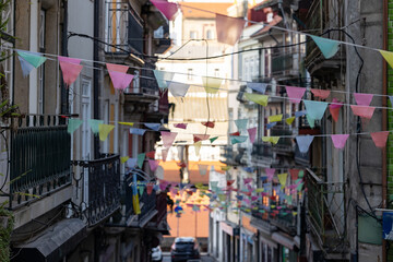 Fototapeta na wymiar Colorful flags on street of old city - eropean town