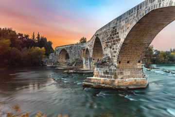 The historical Aspendos Bridge over Koprucay at sunrise in Antalya Turkey - obrazy, fototapety, plakaty