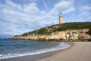 Fototapeta na wymiar View of Hercules tower roman lighthouse from Lapas beach in the city of a coruna in a sunny day, Galicia, Spain
