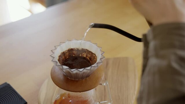 Process of brewing pour over coffee with V60 decanter. Extremely close-up shot of the finished hot beverage dripping into the dispensing container