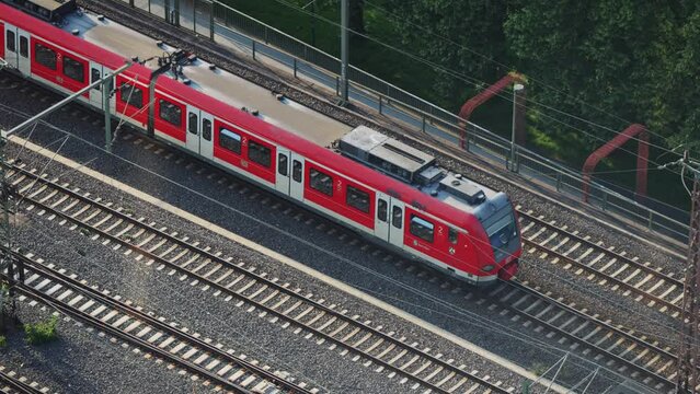 S-Bahn regional suburban speed train drive in Cologne at Hohenzollern bridge in Germany, aerial shot
