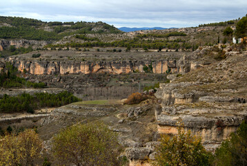 Fototapeta na wymiar Landscape with a panoramic view of mountains and greenery against a blue sky with clouds in the city of Cuenca, near Madrid, Spain