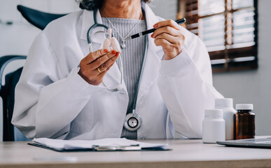 Female doctor holding virtual Lungs in hand. Handrawn human organ, copy space on right side, raw photo colors. Healthcare hospital service concept stock photo