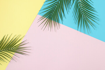 Tropical bright colorful background with exotic tropical palm leaves. Minimal fashion summer concept. Flat lay.