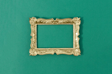 Gold vintage frame on green background. Minimal border composition.