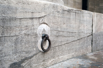 Wrought iron ring on a stone wall.