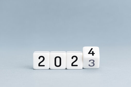 New Year concept. Change from 2023 to 2024 cube blocks isolated on blue background. Copy space
