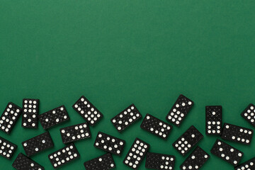 Black domino tiles on color background, top view