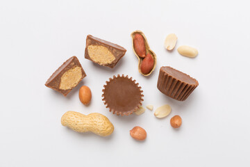 Tasty chocolate peanut butter cups on color background, top view