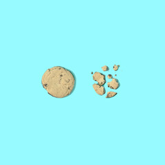 Broken homemade cookies on blue background. Creative food concept. Flat lay.