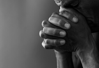 man praying to God with the bible on black background with people stock image stock photo