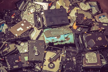 Pile of old old hard drives for recycling. E-waste background