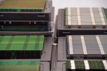Stacks of new RAM sticks in a black plastic container. Macro shot