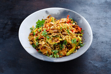 Traditional Thai Pad Mama with Instand noodles, chicken and vegetable served as a close-up on a...