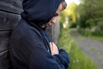 Fototapeta premium teenage boy walking in the village in summer