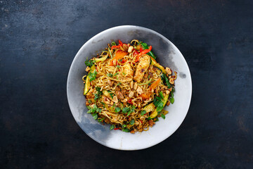 Traditional Thai Pad Mama with Instand noodles, chicken and vegetable served as top view on a design plate with text space