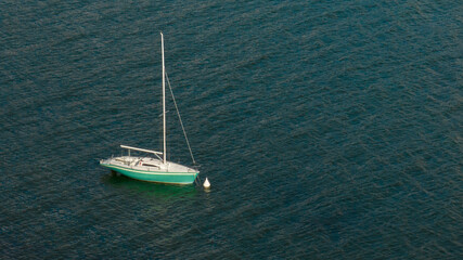 Aerial view of a small boat anchored in the middle of the sea.