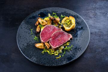 Fried Italian chianina beef fillet steak very rare with mushrooms, chopped pistachios and Beignet...