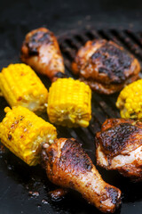 Chicken legs with grilled corn.style rustic