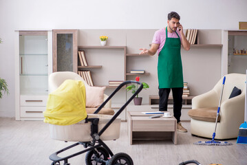Young male contractor cleaner looking after newborn