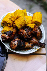 Chicken legs with grilled corn.style rustic